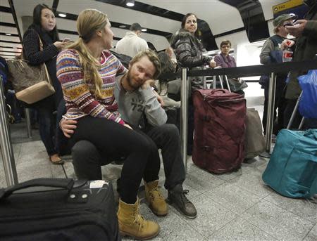 Passengers queue in Terminal 3 at Heathrow Airport in west London December 7, 2013. REUTERS/Luke MacGregor