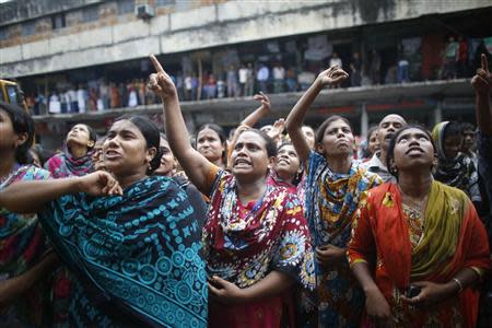 Garment workers shout as they call other workers to join them, in front of Brothers Fashion Limited, during a protest in Dhaka September 23, 2013. REUTERS/Andrew Biraj