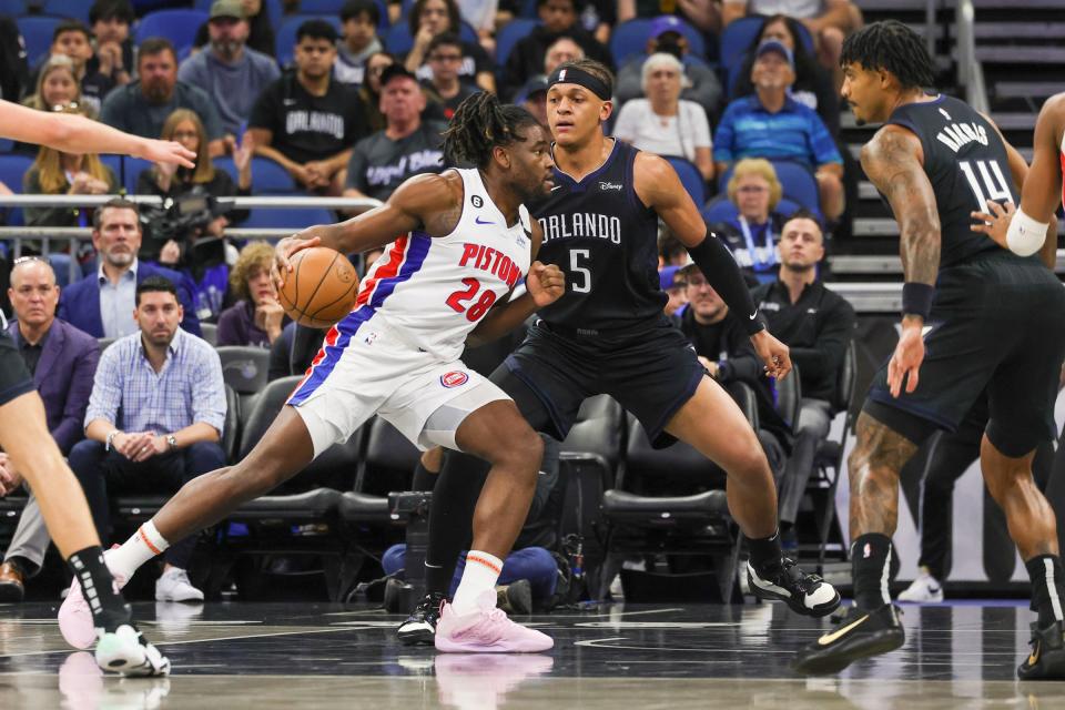 Pistons center Isaiah Stewart drives to the basket against Magic forward Paolo Banchero during the first quarter on Thursday, Feb. 23, 2023, in Orlando, Florida.
