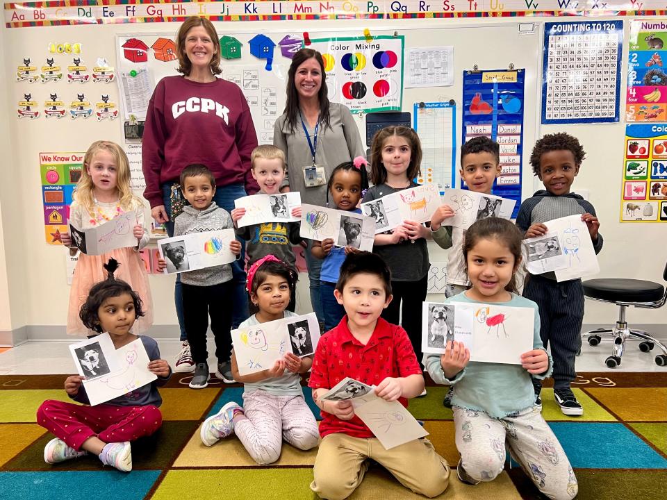 Students at Children’s Corner Preschool in Piscataway hold their drawings of dogs awaiting adoption at Edison Animal Shelter, along with photos of the animals. The children are with Principal Jennifer Sernotti and art teacher Paige Berkowitz, who initiated the project.
