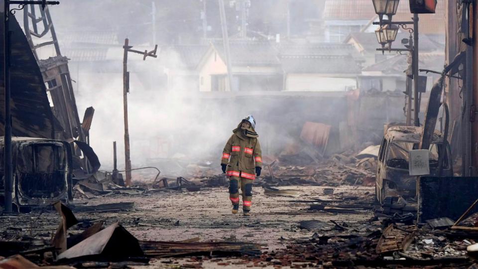 PHOTO: A firefighter looks up the rubble and wreckage of a burnt-out marketplace following earthquake in Wajima, Ishikawa prefecture, Japan, Tuesday, Jan. 2, 2024. (Kyodo News via AP)