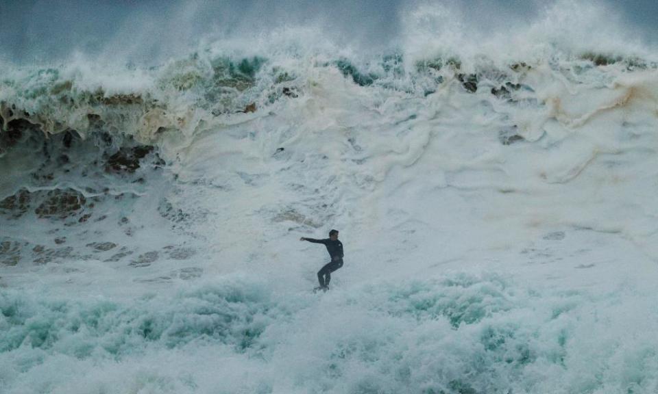 A surfer rides a wave at South Narrabeen on Monday