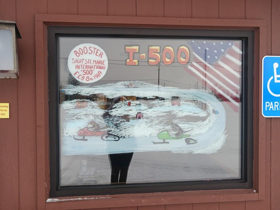 Part of the window decoration of the Sault Animal Hospital is seen during the I-500 weekend business decoration contest.