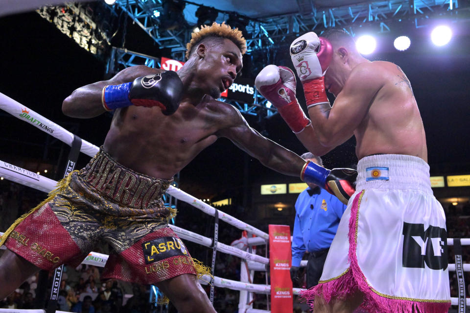 Jermell Charlo (gold/red shorts) exchanges punches in the ring with Brian Castano (white/pink shorts) during their super middleweight title fight at Dignity Health Sports Park on May 14, 2022 in Carson, Calif. (Jayne Kamin-Oncea, Getty Images)