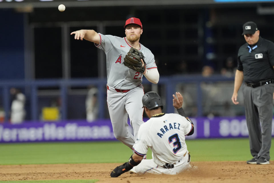 Los Angeles Angels second baseman Brandon Drury (23) outs Miami Marlins' Luis Arraez (3) and throws to first base to complete the double play during the sixth inning of a baseball game, Monday, April 1, 2024, in Miami. (AP Photo/Marta Lavandier)