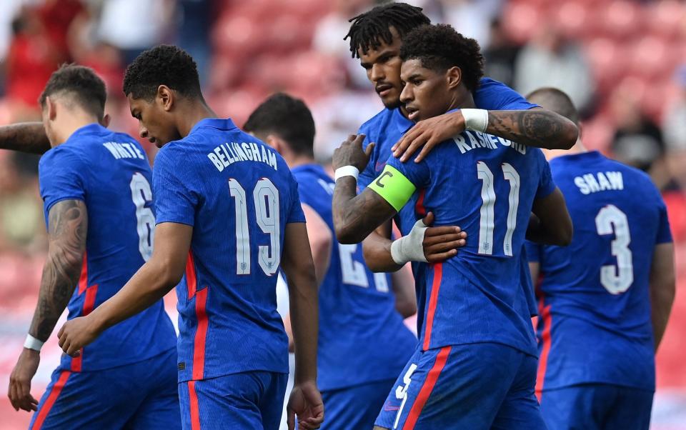 England's striker Marcus Rashford (2R) celebrates scoring his team's first goal with England's defender Tyrone Mings (3R) during the international friendly football match between England and Romania at the Riverside Stadium in Middlesbrough, north-east England on June 6, - GETTY IMAGES