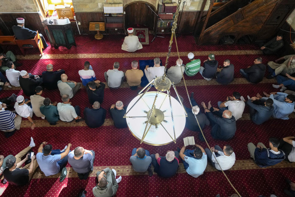 Muslims pray for the safety of the Palestinian people during a Friday prayer at Bajrakli Mosque in Belgrade, Serbia, Friday, Oct. 13, 2023. In Muslim communities across the world, worshippers gathered at mosques for their first Friday prayers since Hamas militants attacked Israel, igniting the latest Israel-Palestinian war. (AP Photo/Darko Vojinovic)