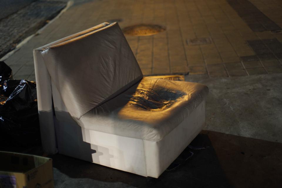 In this Jan. 24, 2014 photo, a well-worn sofa sits in a garbage pickup area in Buenos Aires, Argentina. Argentines have suffered through a tough summer, with tropical rain that provided no relief from the heat and humidity, people having to throw out rotten food because of rolling power blackouts and soaring oil and gas prices, all amid rising inflation that is making it ever harder to reach the end of the month. The strain is evident on the faces of subway riders and others making their way home in Buenos Aires, where signs of poverty and decay are ubiquitous just beyond the glamorous streets where tourists go.(AP Photo/Rodrigo Abd)