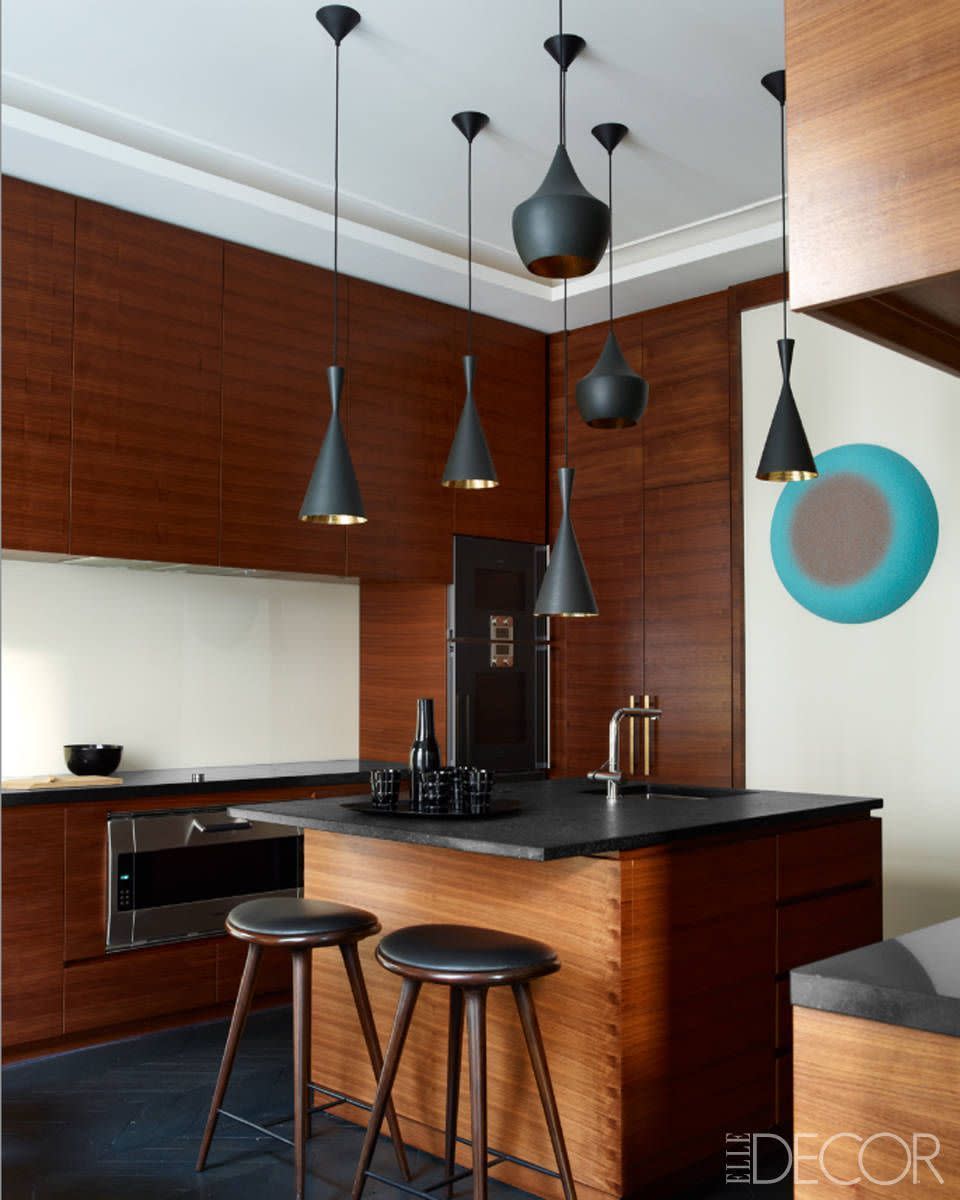 a kitchen with a bar and stools