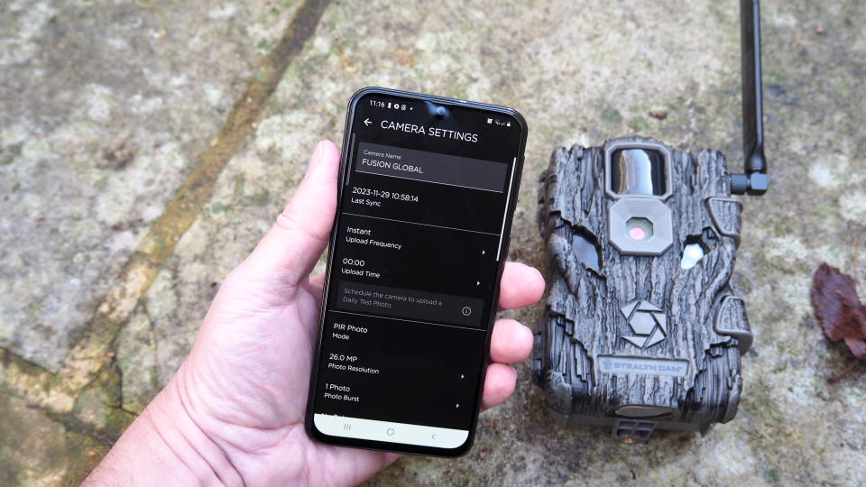 iPhone with image on the screen being held next to a Stealth Cam Fusion Global