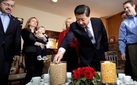 Xi Jinping looks at vases full of soybeans and corn as Iowa Gov. Terry Branstad (L) looks on during a visit to the Rick Kimberley family farm on February 16, 2012 in Maxwell, Iowa - Credit:  Charlie Neibergall/AFP / Getty Images