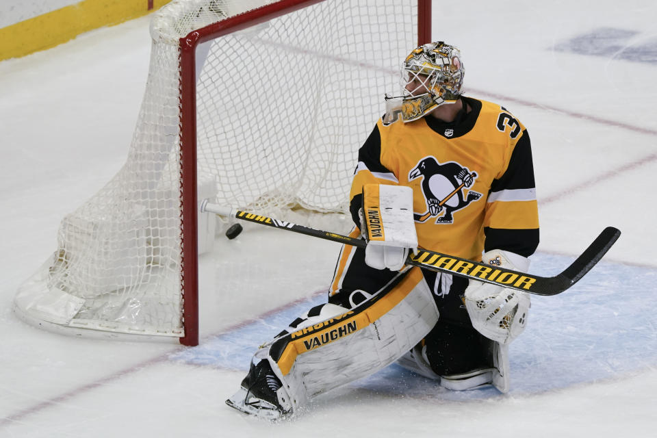 Pittsburgh Penguins goaltender Tristan Jarry looks behind him at the puck on a goal scored by Philadelphia Flyers' Scott Laughton that tied the score during the third period of an NHL hockey game Thursday, March 4, 2021, in Pittsburgh. (AP Photo/Keith Srakocic)