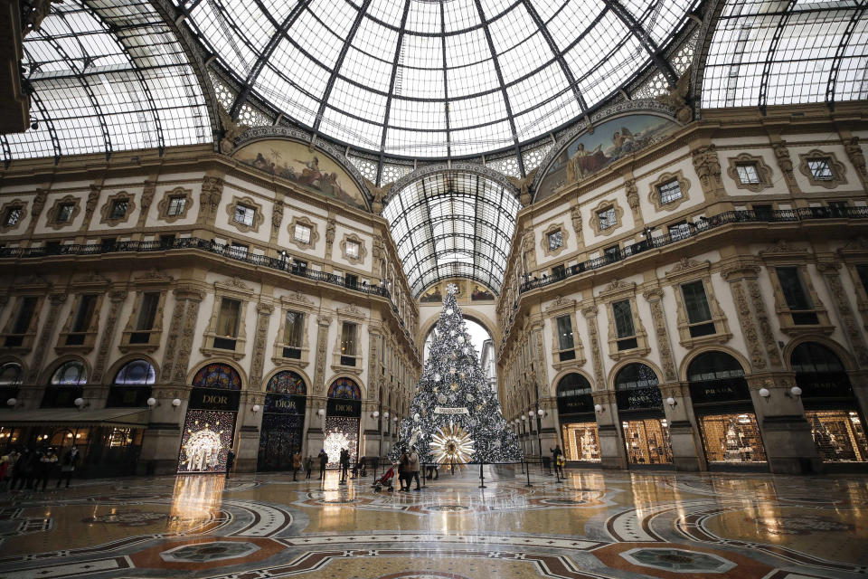 The almost deserted Galleria Vittorio Emanuele II shopping arcade, in Milan, Italy, Thursday, Dec. 24, 2020. Italy went into a modified nationwide lockdown Thursday for the Christmas and New Year period, with restrictions on personal movement and commercial activity similar to the 10 weeks of hard lockdown Italy imposed from March to May when the country became the epicenter of the outbreak in Europe. (AP Photo/Luca Bruno)