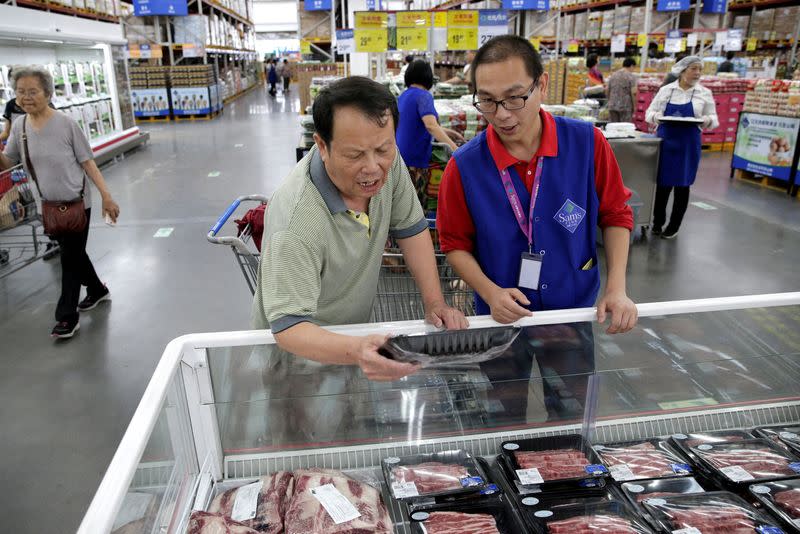 FILE PHOTO: A customer checks the beef steaks at a Sam's Club store of Wal-Mart in Beijing