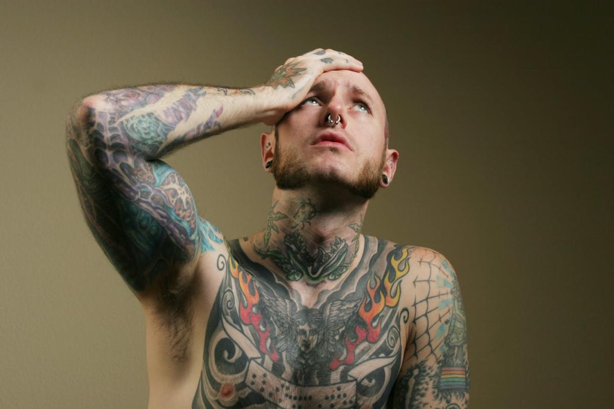 <span class="caption">About one in four people regrets having tattoos. </span> <span class="attribution"><a class="link " href="http://www.shutterstock.com/pic-4205917/stock-photo-tattoo-man-with-headache.html?src=4ycHcrsuQD-7BWOkN56KJQ-1-5" rel="nofollow noopener" target="_blank" data-ylk="slk:From www.shuttertock.com;elm:context_link;itc:0;sec:content-canvas">From www.shuttertock.com</a></span>