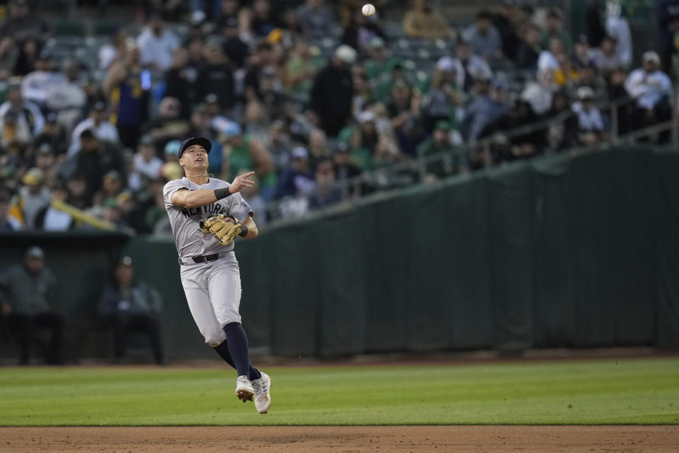 New York Yankees shortstop Anthony Volpe throws out Oakland Athletics' Brent Rooker at first base to end the third inning of a baseball game Saturday, Sept. 21, 2024, in Oakland, Calif. (AP Photo/Godofredo A. Vásquez)