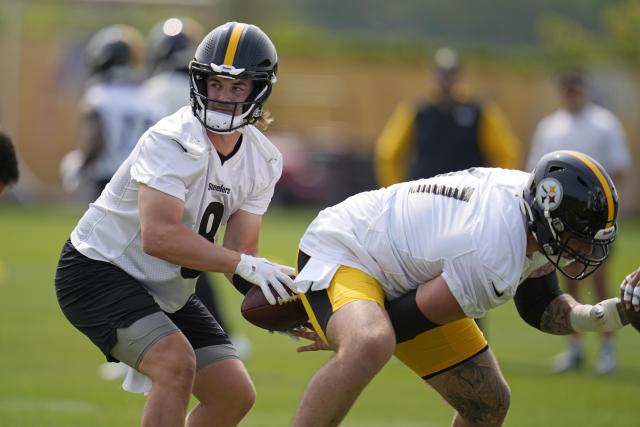 Pittsburgh Steelers quarterbacks Kenny Pickett, left, takes a snap during the NFL football team's OTA's in Pittsburgh, Tuesday, May 23, 2023. (AP Photo/Gene J. Puskar)