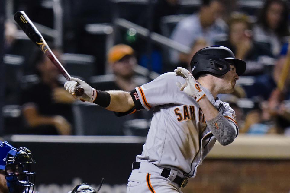 San Francisco Giants' Mike Yastrzemski follows through on a single during the ninth inning of the team's baseball game against the New York Mets on Thursday, Aug. 26, 2021, in New York. (AP Photo/Frank Franklin II)