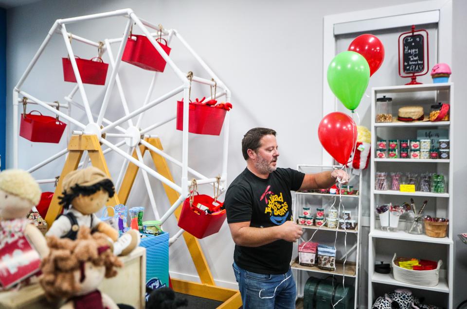 Justin Cooper uses some balloons to dress up his toy store, Jughead and Beans, before opening recently in Norton Commons on Meeting Street. The first-time business owner is a former teacher who wanted to operate his own toy store after ToysRus closed. His store features educational games, wooden toys, books and small items for under $6.