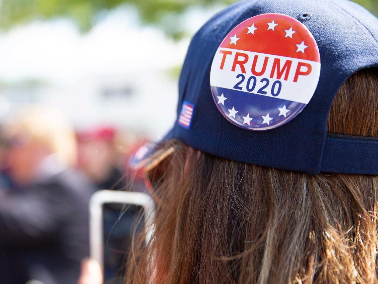 A woman prepares for a Trump rally in New Hampshire, which the president lost by less than half a point: EPA