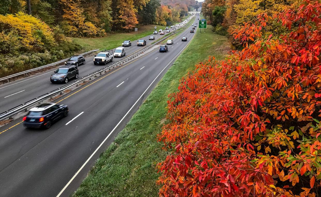 New Canaan, CT, USA - October 22, 2020: Autumn colors around Merritt Parkway in Connecticut with evening traffic