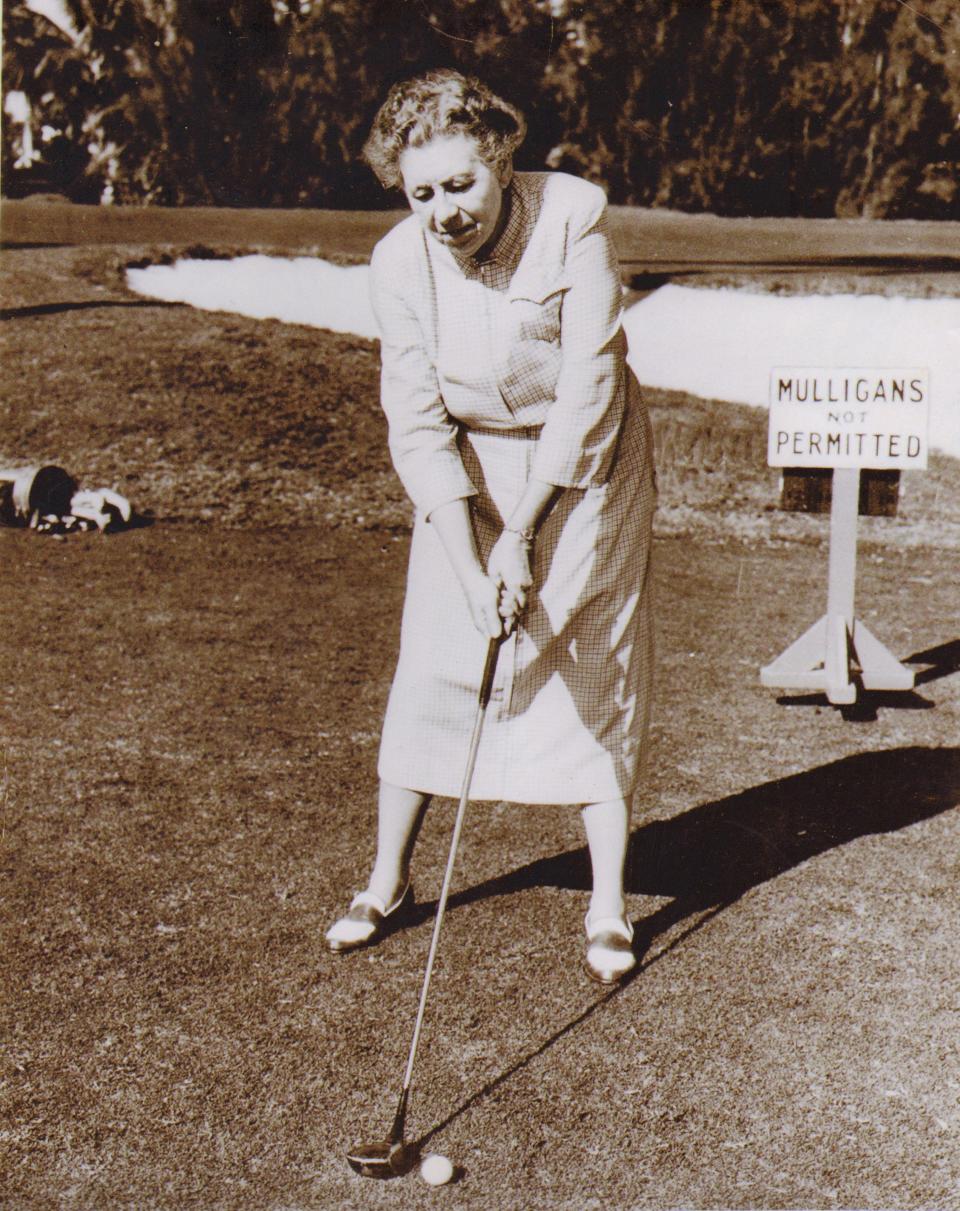 Bessie Fenn, circa 1940, setting up for a drive at the first tee of the Palm Beach Golf Club.