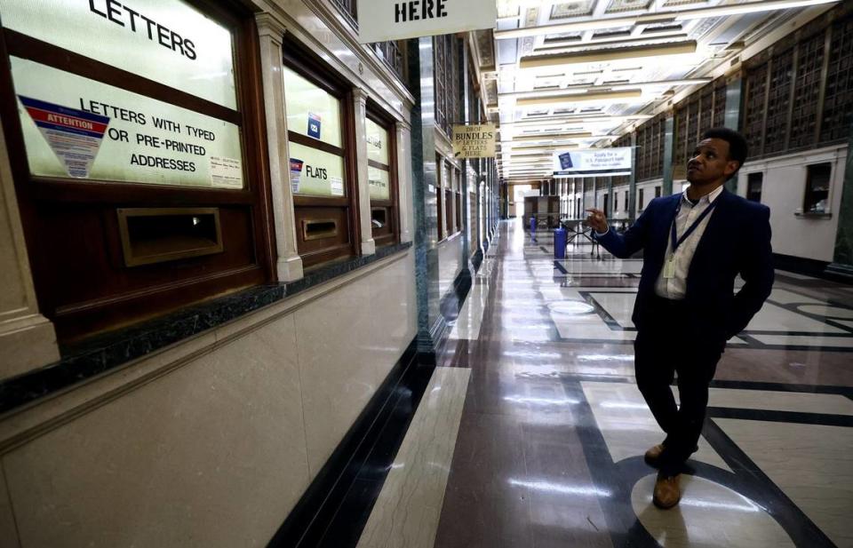 Errik Ford, station manager of the downtown Fort Worth post office, points out the original brass mailboxes still in use on Friday, Aug. 16, 2024.