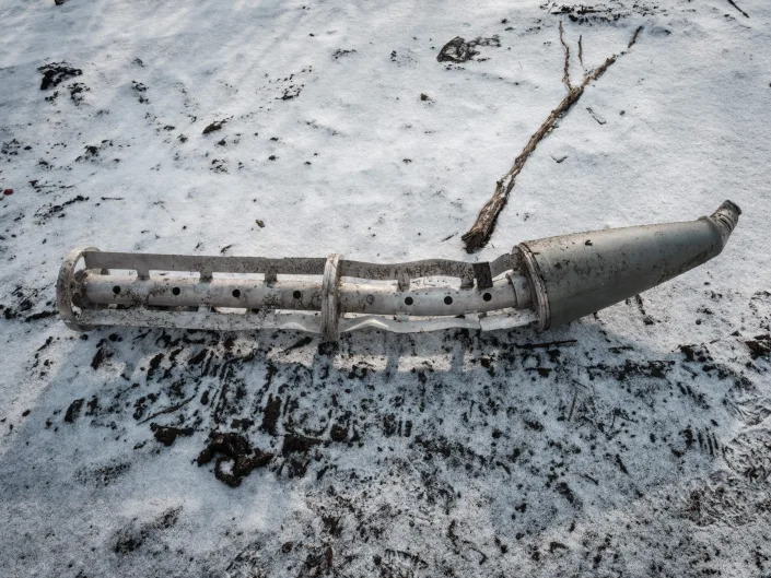 A casing of a cluster bomb rocket lays on the snow-covered ground in Zarichne on February 6, 2023, amid the Russian invasion of Ukraine.
