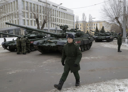 FILE PHOTO: A Russian serviceman walks past T-90 tanks before the military parade to commemorate the 75th anniversary of the battle of Stalingrad in World War Two, in the city of Volgograd, Russia, February 2, 2018. REUTERS/Tatyana Maleyeva/File Photo