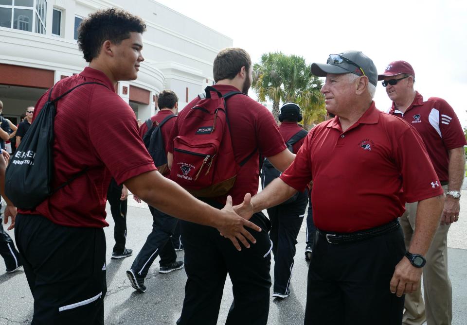 Florida Tech football players shake hands with former university president Anthony Catanese during the "Panther Walk" before a 28-26 home win over West Georgia in November 2015.