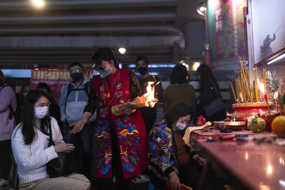 A practitioner performs a "villain hitting" ceremony on the day of "ging zat," as pronounced in Cantonese, which on the Chinese lunar calendar literally means "awakening of insects," under the Canal Road Flyover in Hong Kong on Monday, March 6, 2023. (AP Photo/Louise Delmotte)