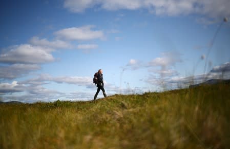 Kathryn Bennett, a postgraduate student in earth sciences at the University of New Hampshire, walks through an area of marshland at an Arctic research post at Stordalen Mire neat Abisko