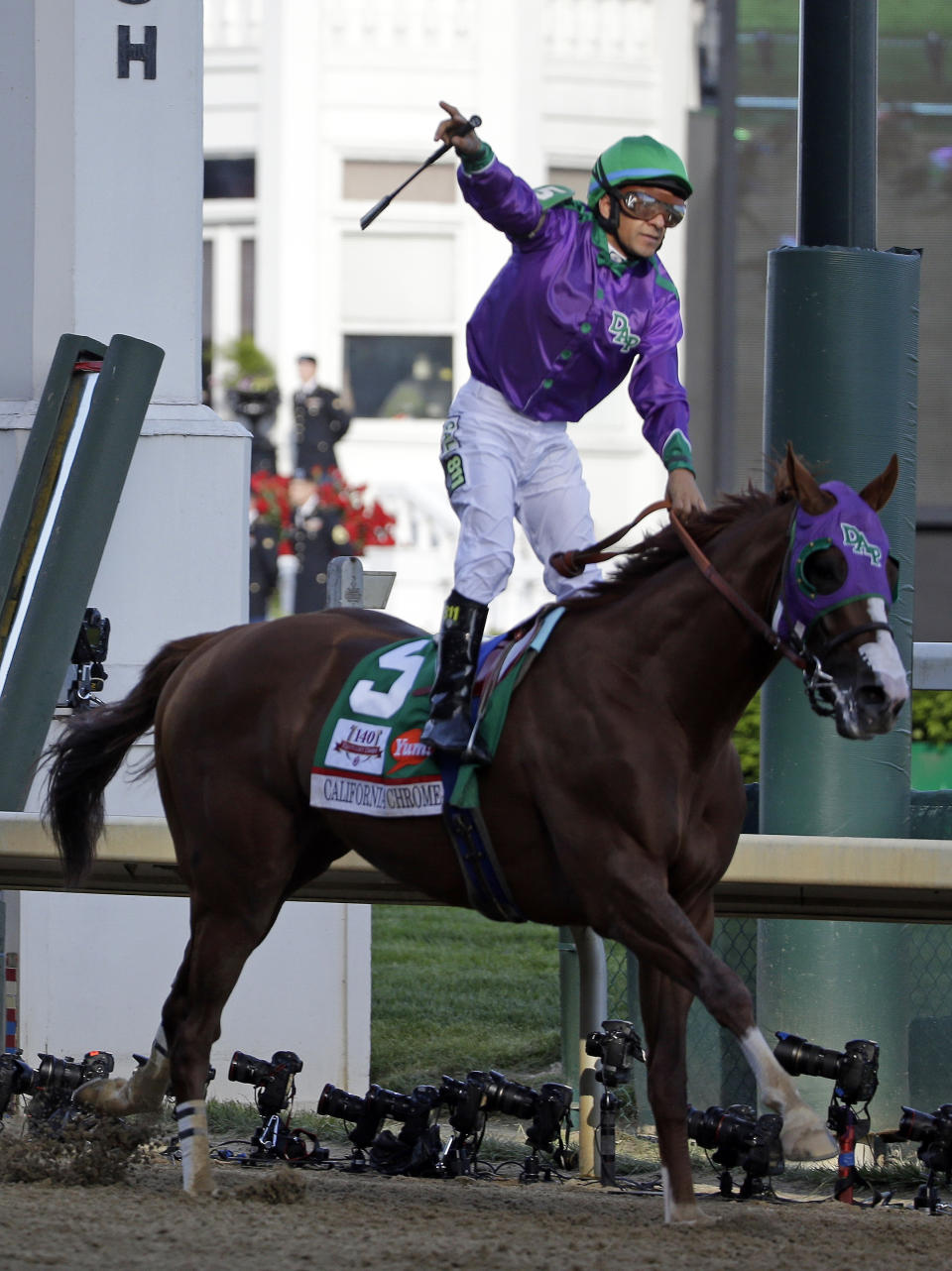 Victor Espinoza celebrates after riding California Chrome to victory during the 140th running of the Kentucky Derby horse race at Churchill Downs Saturday, May 3, 2014, in Louisville, Ky. (AP Photo/David Goldman)