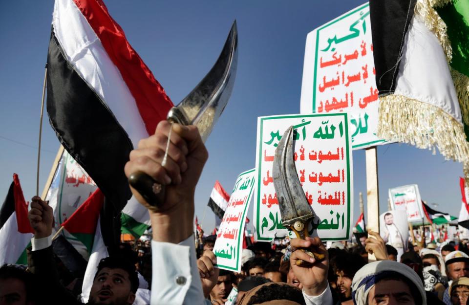 Houthi supporters attend a protest  in Sanaa, Yemen, against the US-led airstrikes (AP)