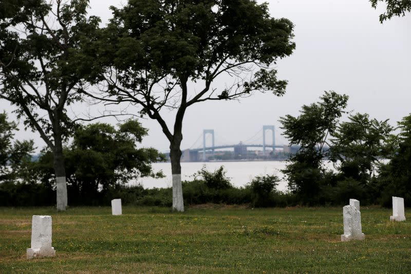 FILE PHOTO: Stones mark mass graves on Hart Island, the former location of a prison and hospital that is a potter's field burial site of as many as one million people, in New York