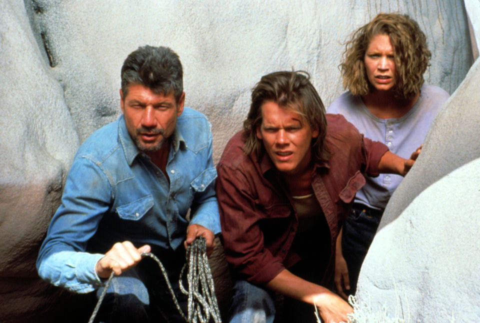 Fred Ward, Kevin Bacon, and Finn Carter staring ahead.