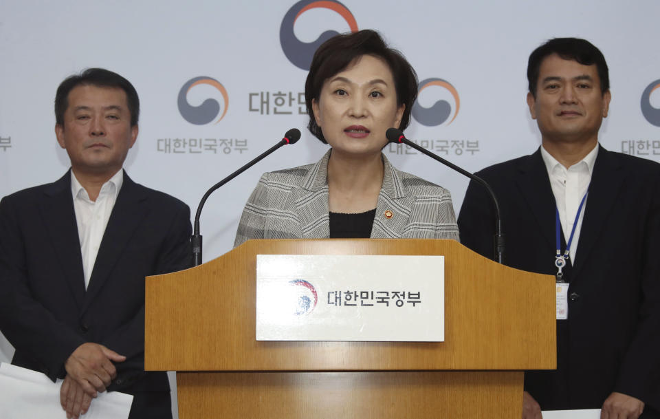 South Korean Minister of Land Infrastructure and Transport, Kim Hyun-mee, center, speaks at a press conference at the government complex in Seoul, South Korea, Tuesday, Aug. 14, 2018. South Korea will ban driving recalled BMWs that haven't received safety checks following dozens of fires the German automaker has blamed on a faulty exhaust gas component. (Kim Seung-doo/Yonhap via AP)