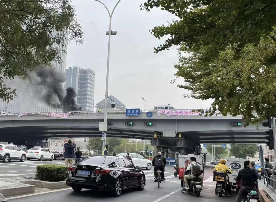 A person was reportedly arrested over the rare display of political disobedience in Beijing.