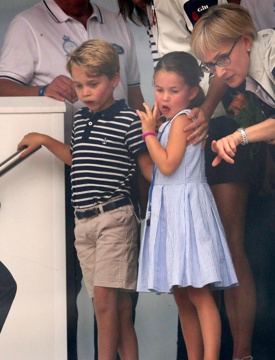 COWES, ENGLAND - AUGUST 08: Prince George of Cambridge and Princess Charlotte of Cambridge look through a window at the prize giving after the King's Cup regatta on August 8, 2019 in Cowes, England. (Photo by Andrew Matthews - WPA Pool/Getty Images)
