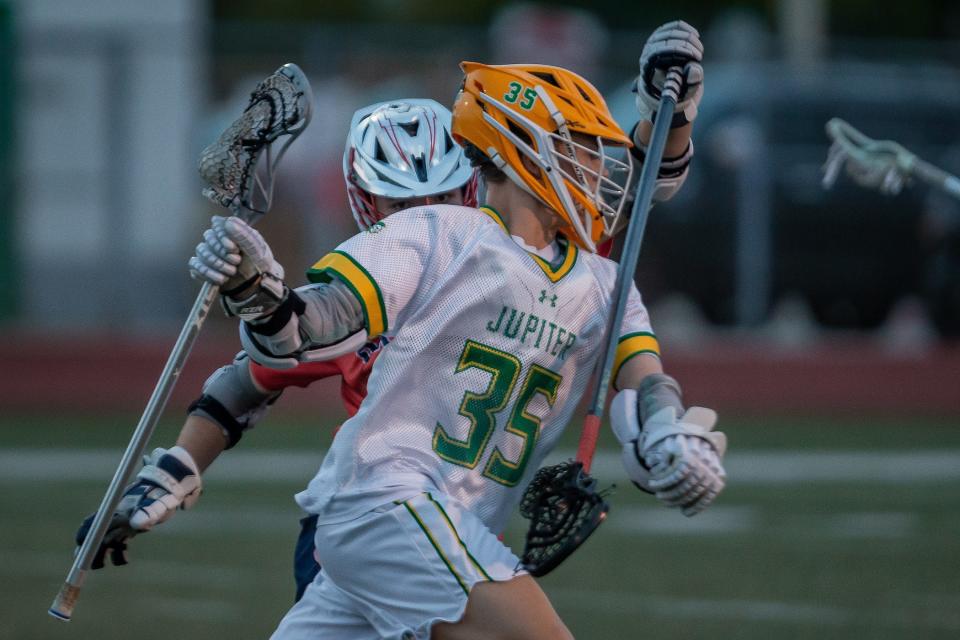 The Jupiter Community High School Warriors hosted the Oxbridge Academy Thunderwolves in a Florida High School Athletic Association boys high school lacrosse game at the school in Jupiter, Fla., on March 26, 2024. The Warriors won 12-5 over the Thunderwolves. Matthew Sofarelli (35) carries the ball during the game.