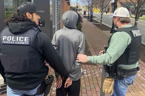 In this image provided by the U.S. Marshals Service, law enforcement personnel take Asir Boone into custody, Tuesday, March 19, 2024, in Alexandria, Va. Boone, the last of four suspects in a shooting that wounded eight Philadelphia high school students at a bus stop earlier this month was captured Tuesday in Virginia. (U.S. Marshals Service via AP)