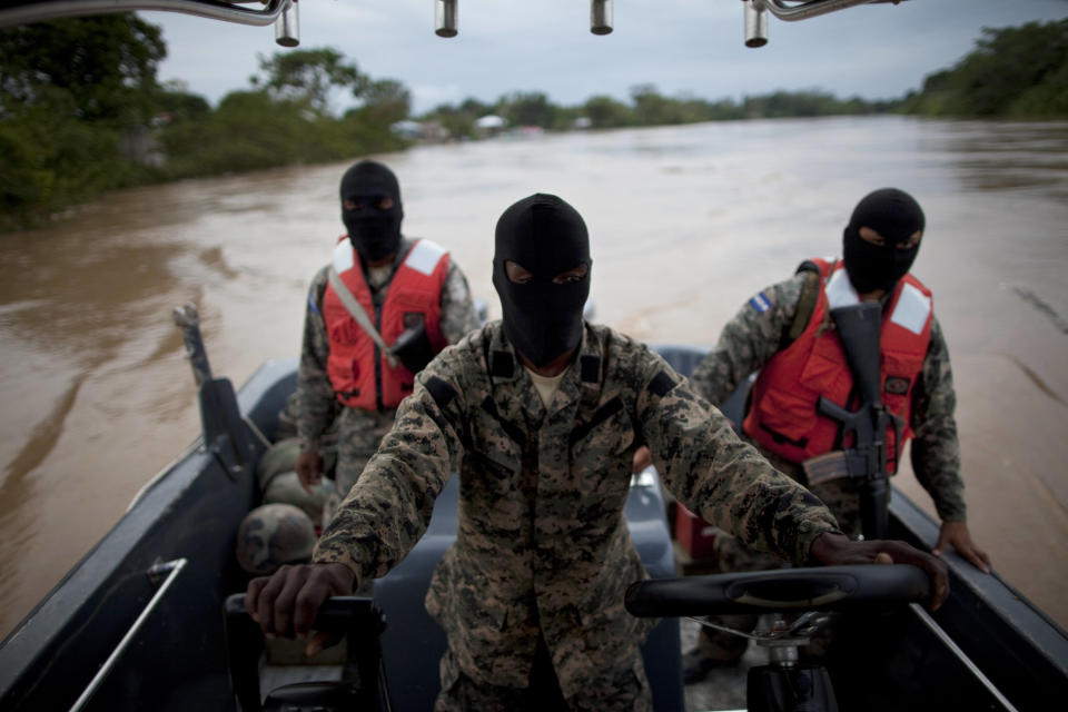 Honduran Navy officers patrol in Patuca river, near Ahuas, a remote community in La Mosquitia region, Honduras, Monday, May 21, 2012. On Friday May 11, a joint Honduran-U.S. drug raid, on a helicopter mission with advisers from the DEA, appears to have mistakenly targeted civilians in the remote jungle area, killing four riverboat passengers and injuring four others. Later, according to villagers, Honduran police narcotics forces and men speaking English spent hours searching the small town of Ahuas for a suspected drug trafficker.(AP Photo/Rodrigo Abd)