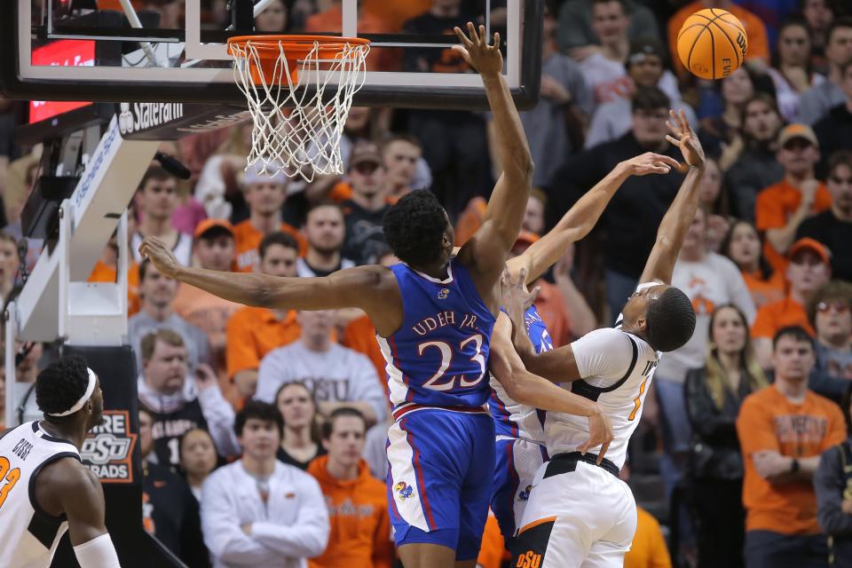 Oklahoma State Cowboys guard Bryce Thompson (1) attempts a basket over Kansas Jayhawks center Ernest Udeh Jr. (23) during a men's college basketball game between the Oklahoma State University Cowboys and the Kansas Jayhawks at Gallagher-Iba Arena in Stillwater, Okla., Tuesday, Feb. 14, 2023. 