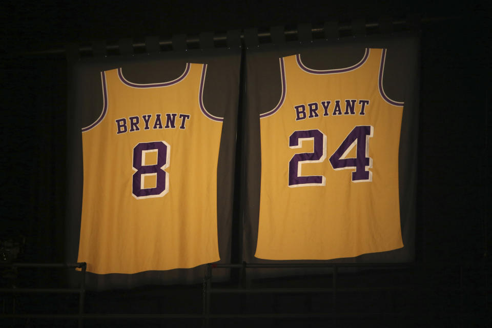 Los Angeles Lakers jersey numbers belonging to retired NBA player Kobe Bryant hang inside Staples Center prior to the start of the 62nd annual Grammy Awards on Sunday, Jan. 26, 2020, in Los Angeles.  Bryant, the 18-time NBA All-Star who won five championships during a 20-year career with the Los Angeles Lakers, died in a helicopter crash Sunday. He was 41.  (Photo by Matt Sayles/Invision/AP)