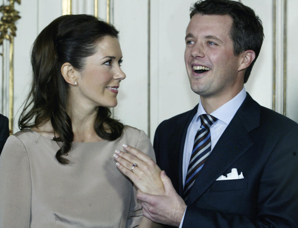 FILE - Denmark's Crown Prince Frederik and his fiancee Mary Donaldson show the engagement ring prior to their news conference at Fredensborg Castle, 35 kilometers (20 miles) north of Copenhagen, Wednesday, Oct. 8, 2003. As a teenager, Crown Prince Frederik felt uncomfortable being in the spotlight, and pondered whether there was any way he could avoid becoming king. All doubts have been swept aside as the 55-year-old takes over the crown on Sunday, Jan. 14, 2024 from his mother, Queen Margrethe II, who is breaking with centuries of Danish royal tradition and retiring after a 52-year reign. (AP Photo/Heribert Proepper, File)