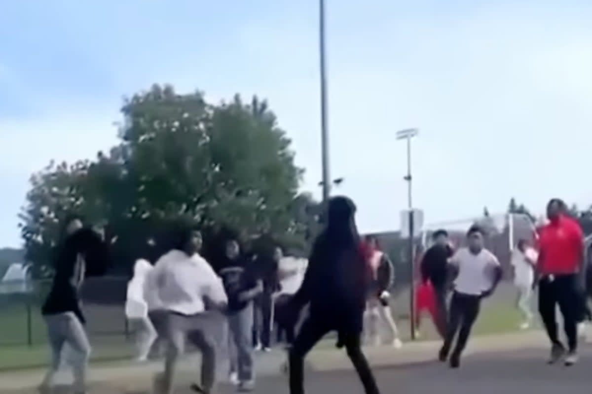 A security guard was shot while trying to break up a fight (pictured) at a high school football game in Utica, New York (WKTV)