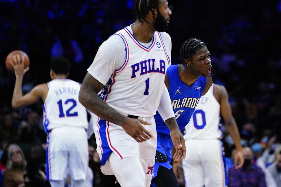 Orlando Magic's Mo Bamba (5) reacts past Philadelphia 76ers' Andre Drummond (1) after making a three-pointer during the first half of an NBA basketball game, Wednesday, Jan. 19, 2022, in Philadelphia. (AP Photo/Matt Slocum)