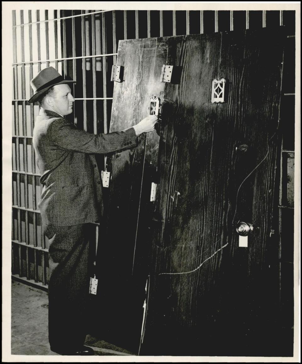 This archive photo from 1949 shows heavy doors with peepholes that once graced the bottom and top of a stairway. They are seen leaning against the sheriff's vault after deputies removed the doors from their hinges at the Hi-Lite Club, 4901 N Lincoln, after a raid on the club's upstairs gambling room.