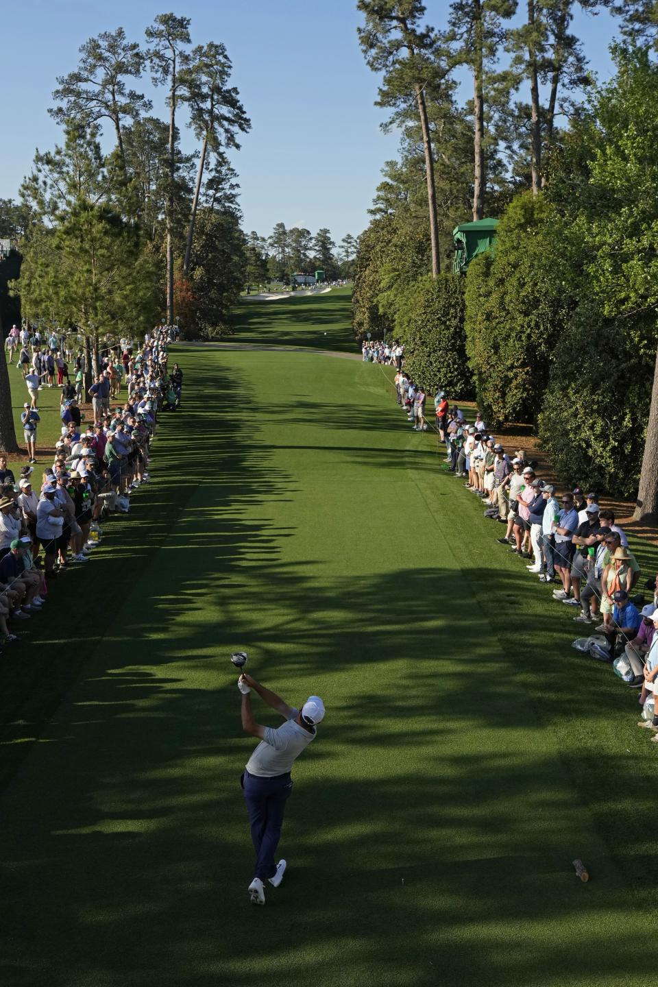 Scottie Scheffler watches his tee shot on the 18th hole during the first round at the Masters golf tournament at Augusta National Golf Club Thursday, April 11, 2024, in Augusta, Ga. (AP Photo/David J. Phillip)