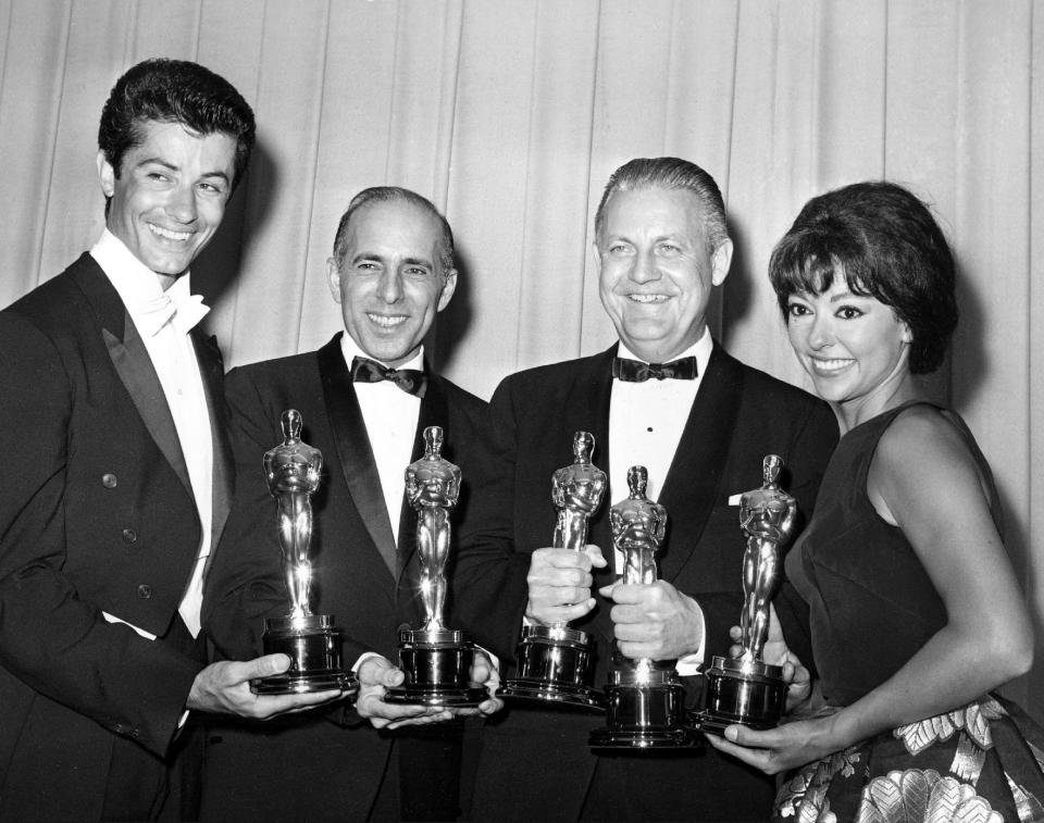 FILE - In this April 9, 1962 file photo, Oscar winners for "West Side Story," from left, actor George Chakiris, co-directors Jerome Robbins and Robert Wise, and actress Rita Moreno, pose at the Academy Awards in Santa Monica, Calif. Moreno is the 50th SAG Life Achievement recipient, to be honored at the Screen Actors Guild Awards, Saturday, Jan. 18, 2014, in Los Angeles. (AP Photo, File)